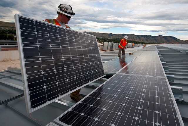 Worker installing solar panels
