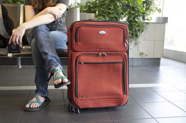 girl waiting on airport with luggage bags