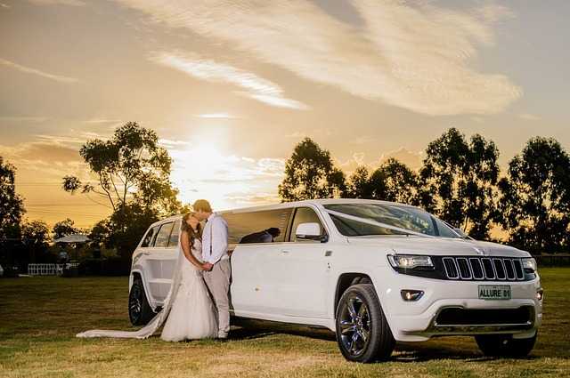 Wedding couple with white limo